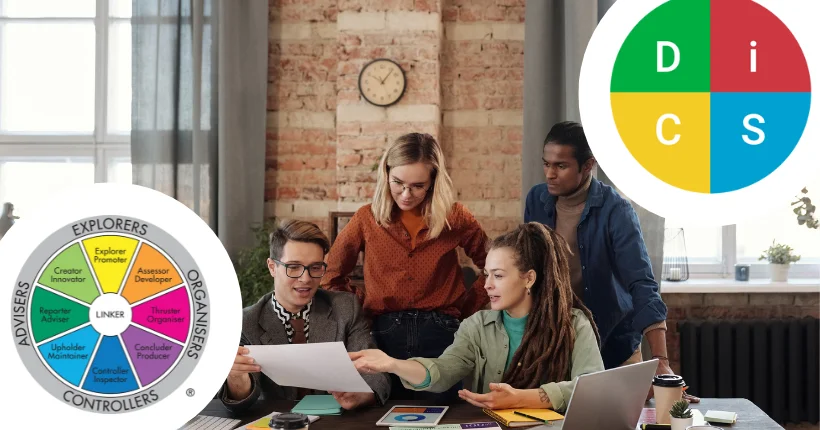 Two professionals comparing assessment approaches representing different psychometric tools for team development