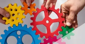 Cross-functional team mapping communication flows and system connections on whiteboard during planning session